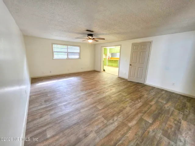 wooden floor in an empty room with a window