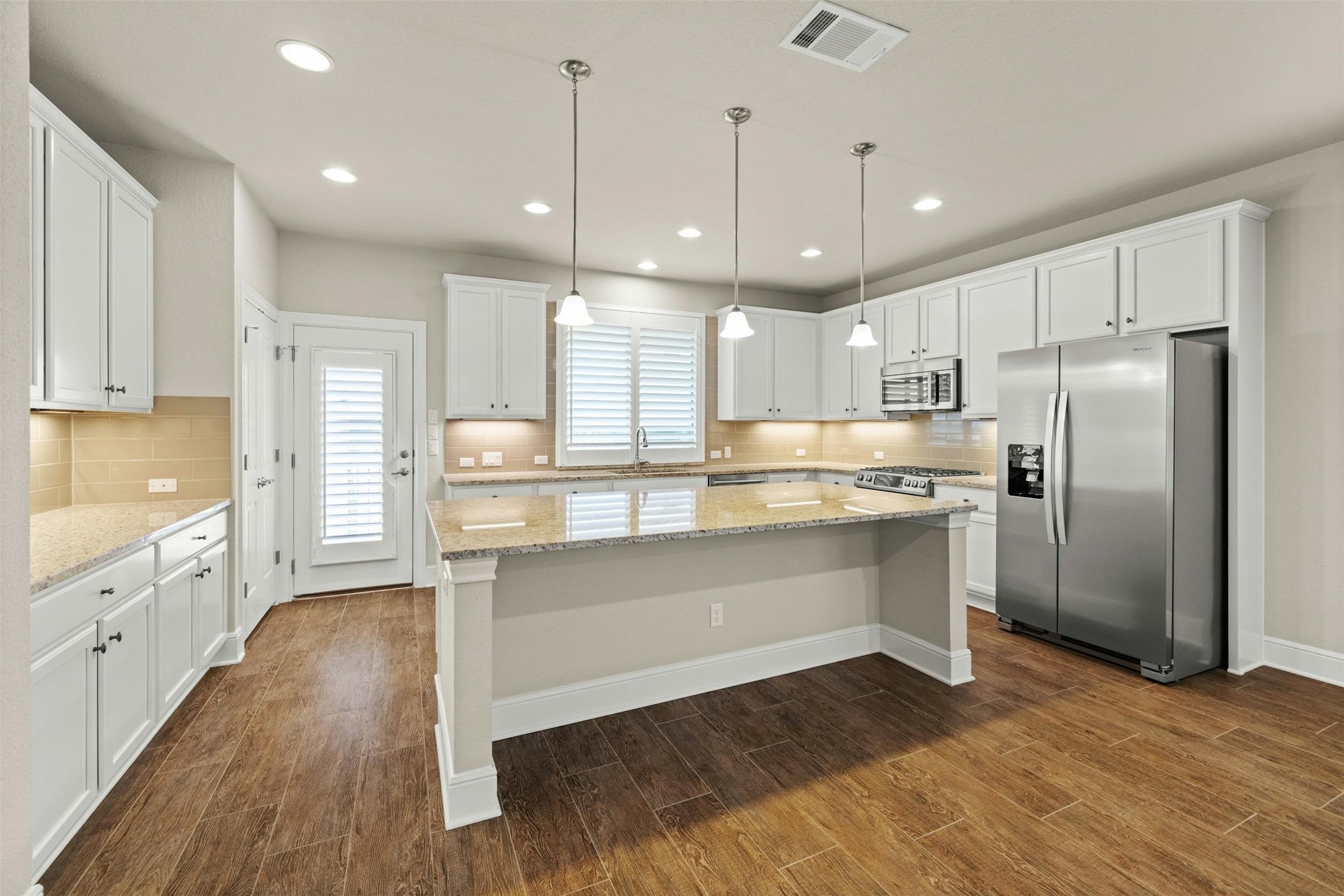 316 Crossvine Trail Georgetown, TX 78626 - Photo 14 of 37 a kitchen with kitchen island a sink stainless steel appliances and cabinets