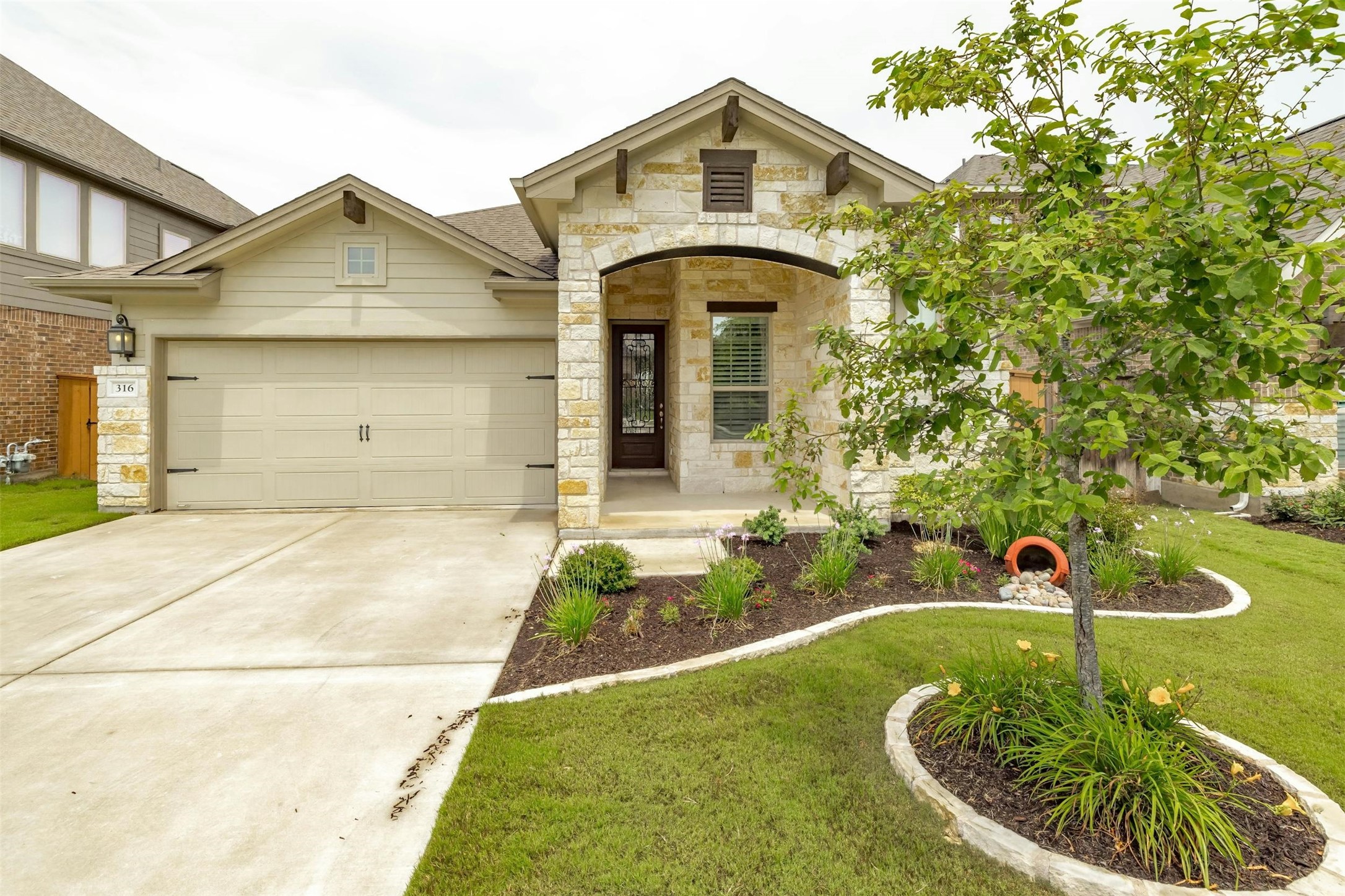316 Crossvine Trail Georgetown, TX 78626 - Photo 2 of 37 a front view of a house with garden