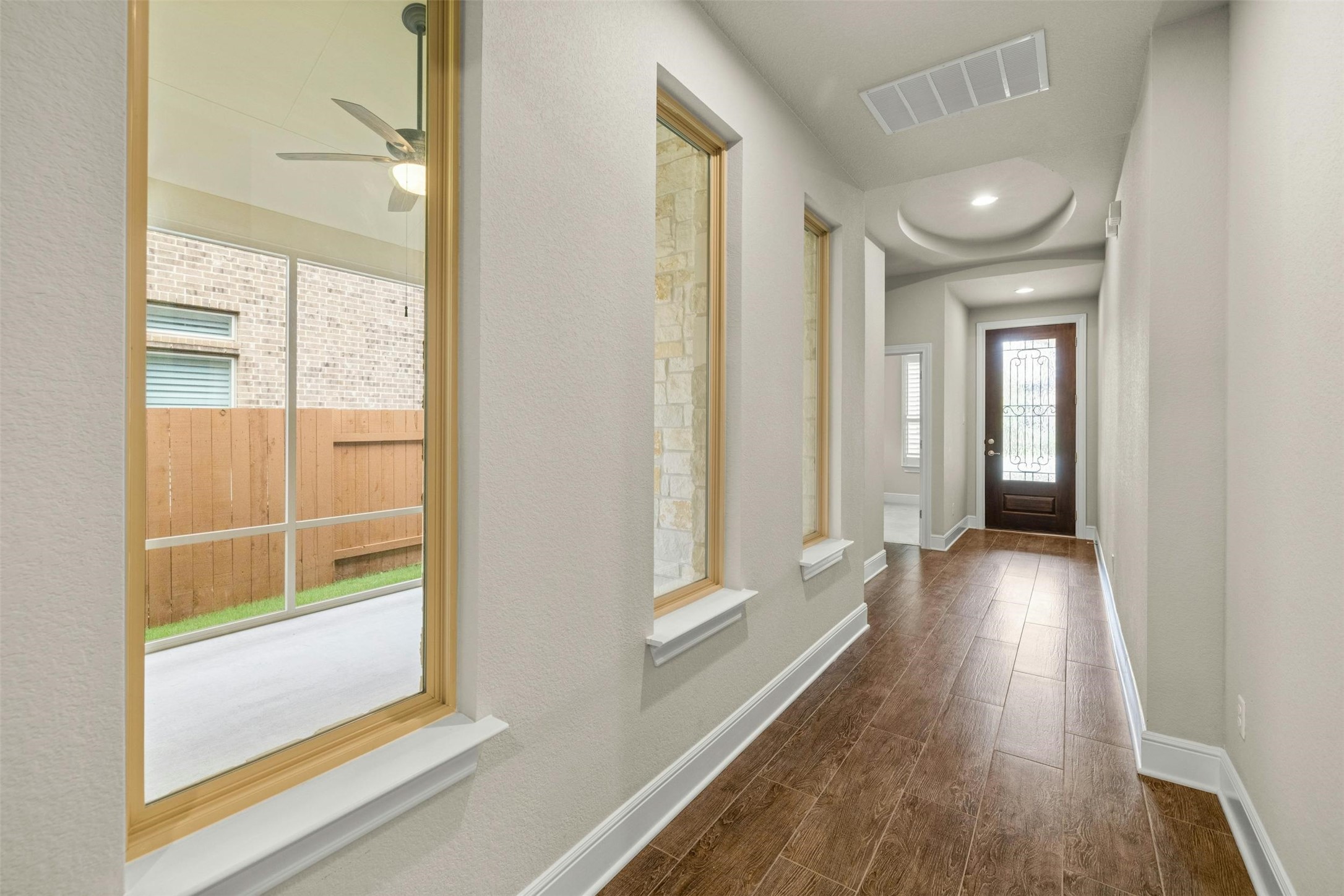 316 Crossvine Trail Georgetown, TX 78626 - Photo 6 of 37 a view of a hallway with wooden floor and a bathroom