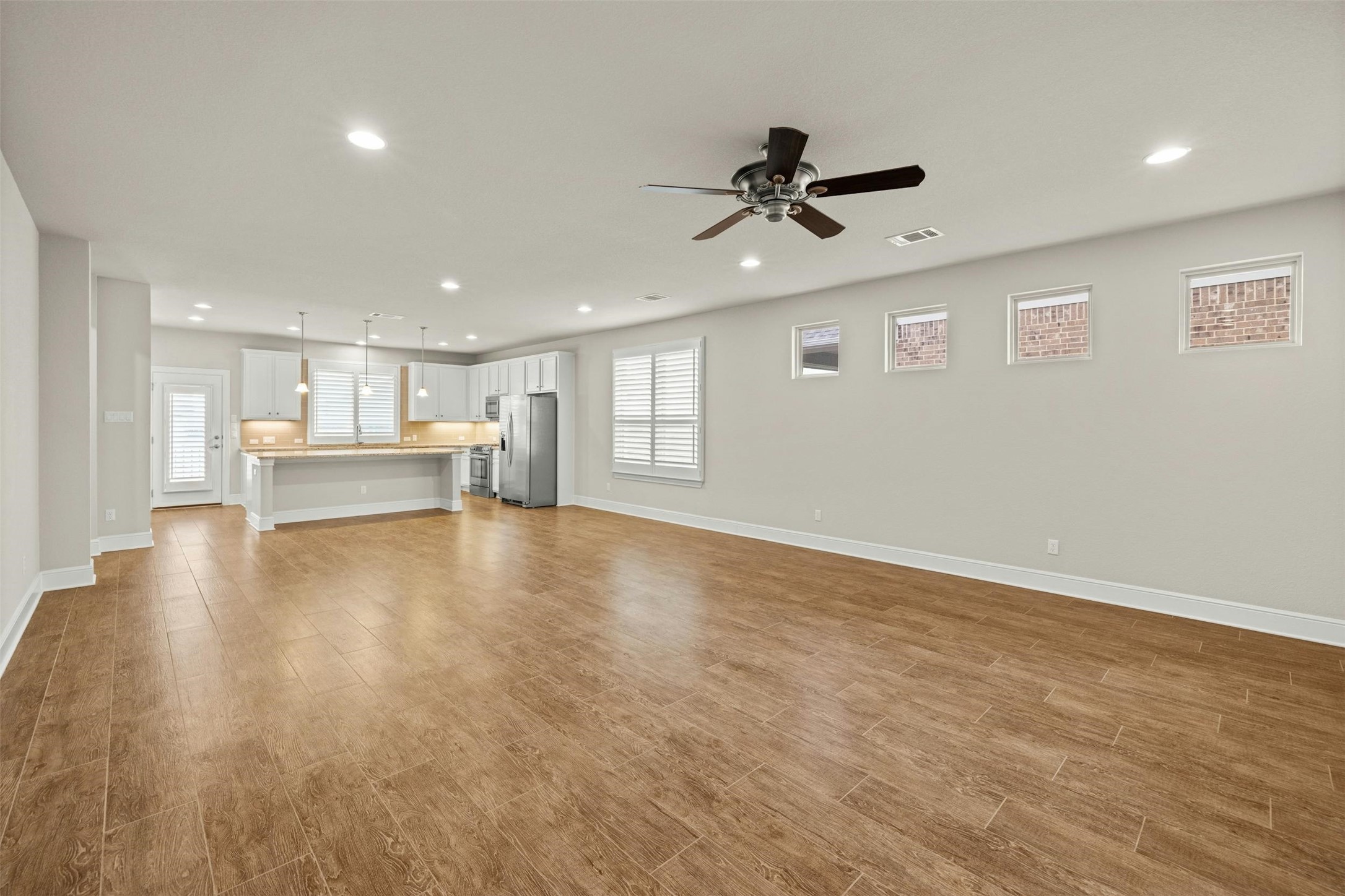 316 Crossvine Trail Georgetown, TX 78626 - Photo 7 of 37 a view of empty room with wooden floor and windows