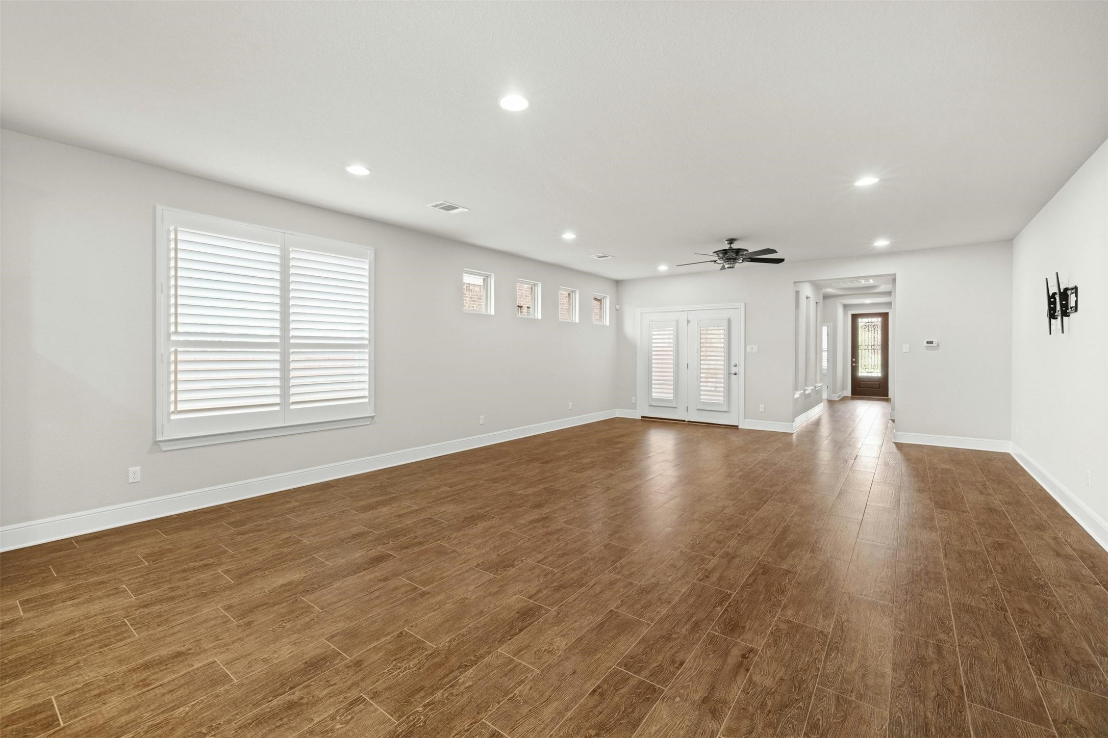 316 Crossvine Trail Georgetown, TX 78626 - Photo 10 of 37 a view of an empty room with wooden floor and a window