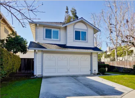 a view of a house with a yard and garage