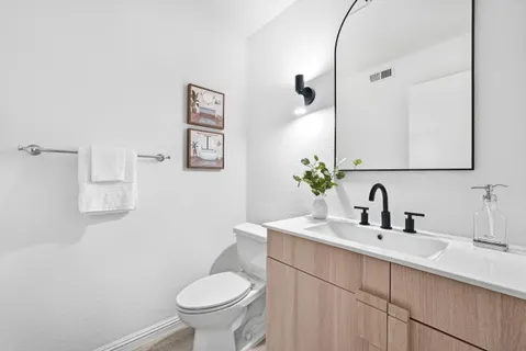 a bathroom with a sink toilet and a mirror