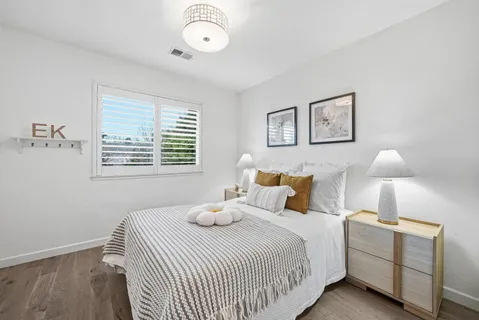 a bedroom with a bed and a lamp