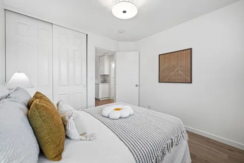 a bedroom with a bed and a chandelier