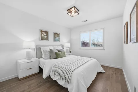 a bedroom with bed and a night stand