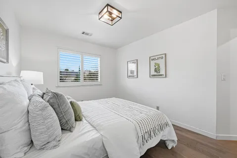 a bedroom with a bed and a window