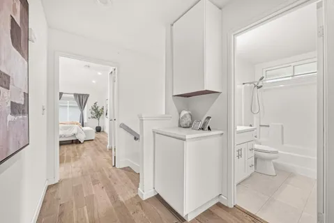 a bathroom with a toilet a sink and a view of bathroom