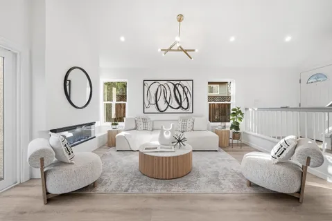 a living room with furniture potted plant and a window