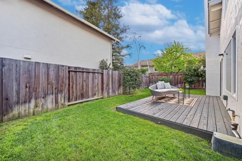 a view of a backyard with sitting area