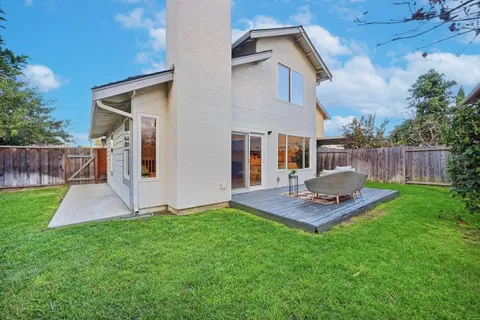 a front view of a house with a yard and outdoor seating