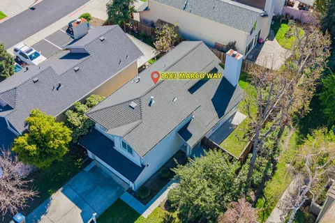 an aerial view of a house with a yard and garden