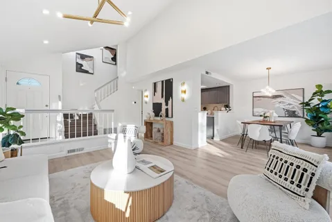 a living room with furniture and a chandelier