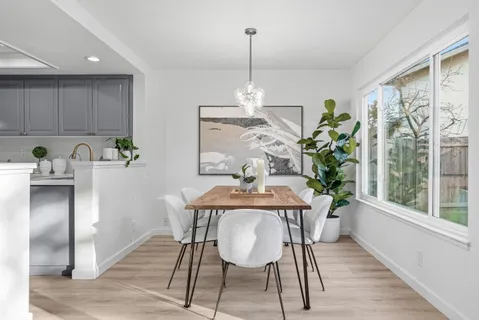 a view of a dining room with furniture window and wooden floor