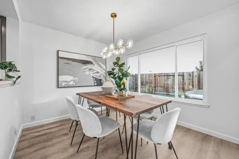 a dining room with furniture and window