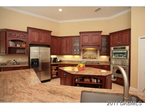 9 Remington Road Ormond Beach, FL 32174 - Photo 13 of 22 a kitchen with stainless steel appliances granite countertop a refrigerator and a stove