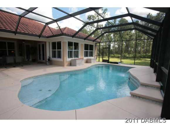 9 Remington Road Ormond Beach, FL 32174 - Photo 20 of 22 front view of a house with a swimming pool