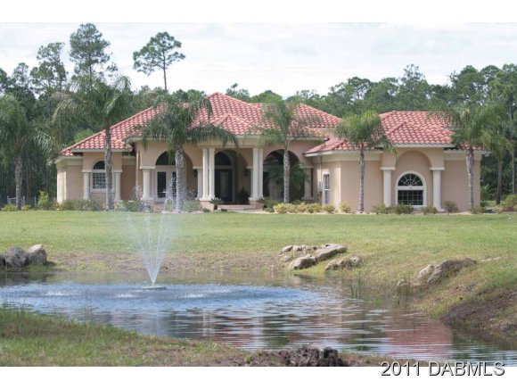 9 Remington Road Ormond Beach, FL 32174 - Photo 3 of 22 a front view of building with yard