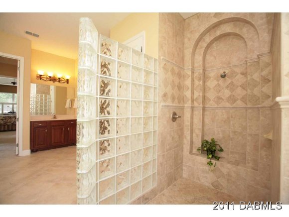 9 Remington Road Ormond Beach, FL 32174 - Photo 5 of 22 a bathroom with a granite countertop sink a mirror and shower