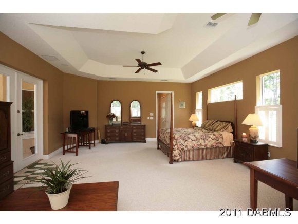 9 Remington Road Ormond Beach, FL 32174 - Photo 7 of 22 a bedroom with furniture and a large window