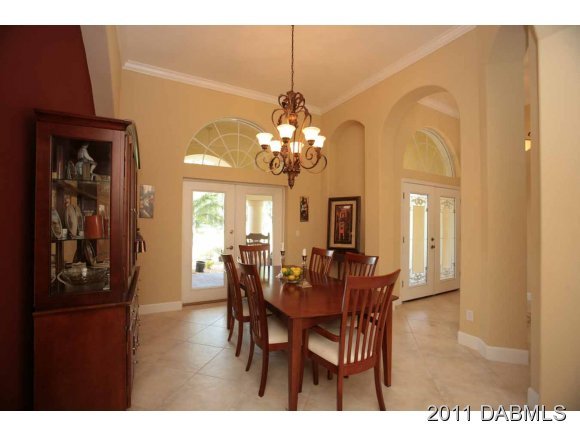 9 Remington Road Ormond Beach, FL 32174 - Photo 10 of 22 a view of a dining room with furniture and chandelier