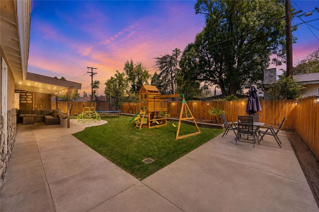 4869 Serrano Place Riverside, CA 92504 - Photo 3 of 40 Spacious backyard designed for fun and relaxing, featuring a grassy play area, patio seating, and room to entertain.