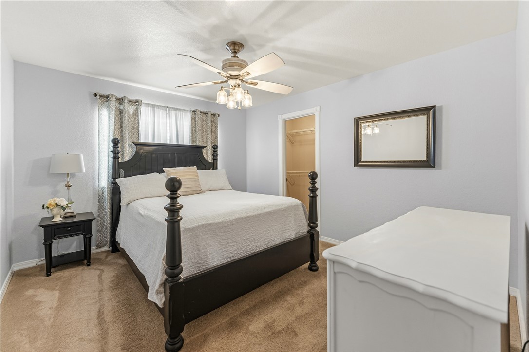 2940 Mountain Trail Road Kingman, AZ 86401 - Photo 14 of 53 a bedroom with a bed and a chandelier