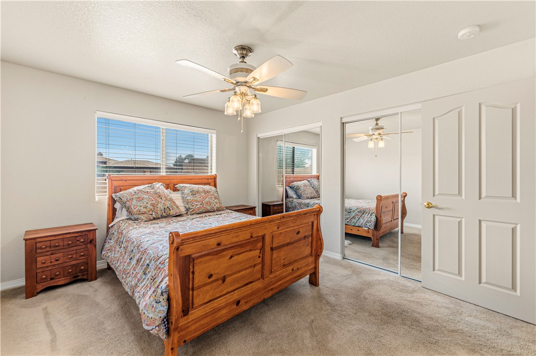 2940 Mountain Trail Road Kingman, AZ 86401 - Photo 15 of 53 a bedroom with a bed and a chandelier