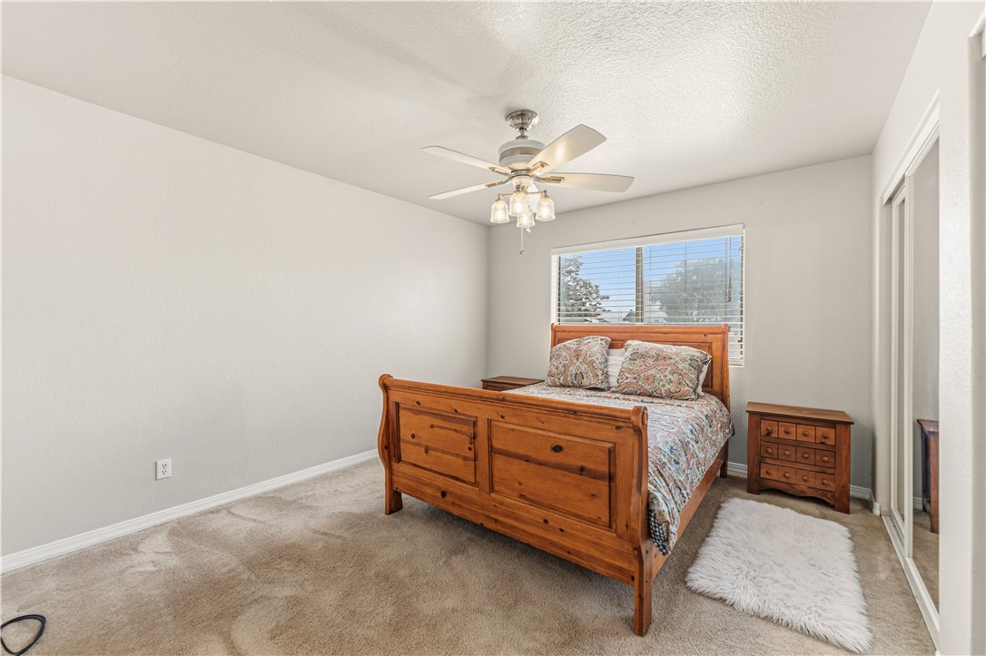 2940 Mountain Trail Road Kingman, AZ 86401 - Photo 16 of 53 a room with a bed and a chandelier