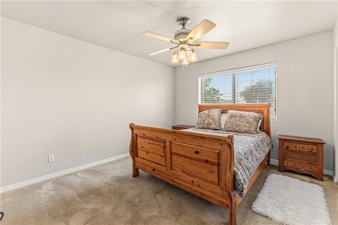 2940 Mountain Trail Road Kingman, AZ 86401 - Photo 17 of 53 a bedroom with a bed and a chandelier