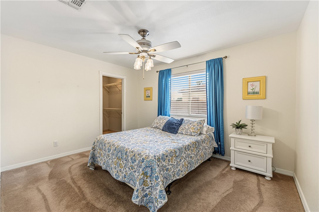 2940 Mountain Trail Road Kingman, AZ 86401 - Photo 18 of 53 a bedroom with a bed and a chandelier