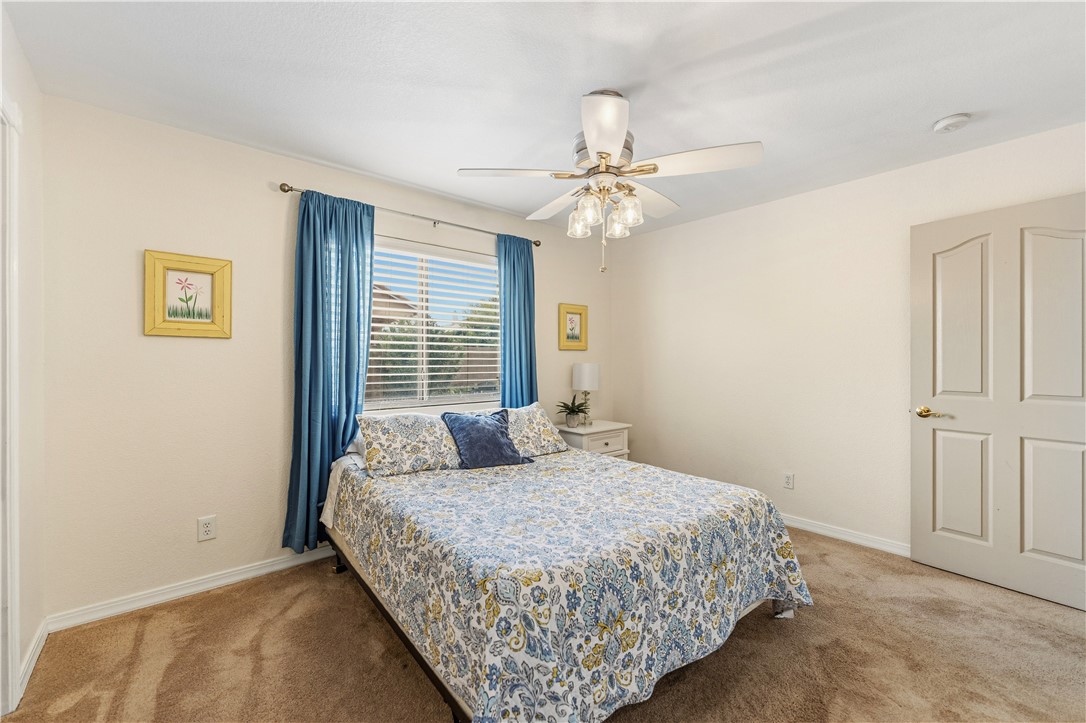 2940 Mountain Trail Road Kingman, AZ 86401 - Photo 19 of 53 a bedroom with a large bed and a chandelier