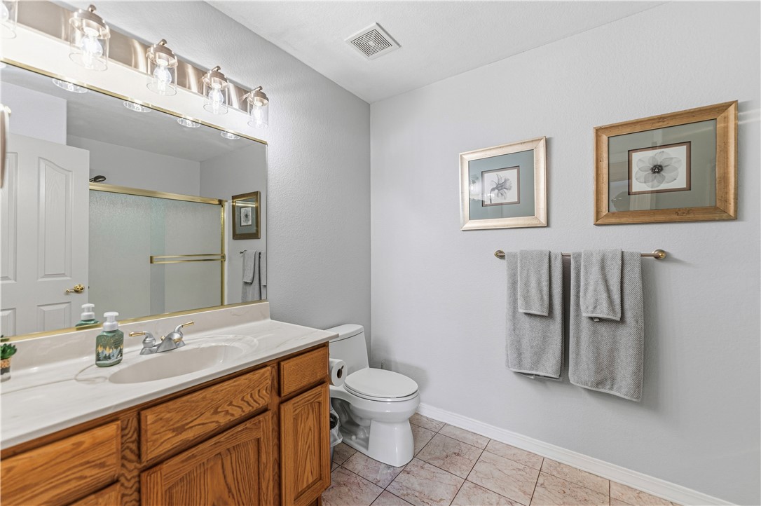 2940 Mountain Trail Road Kingman, AZ 86401 - Photo 20 of 53 Bathroom featuring a vanity with a light wood base, a white countertop, and a large mirror with overhead lighting
