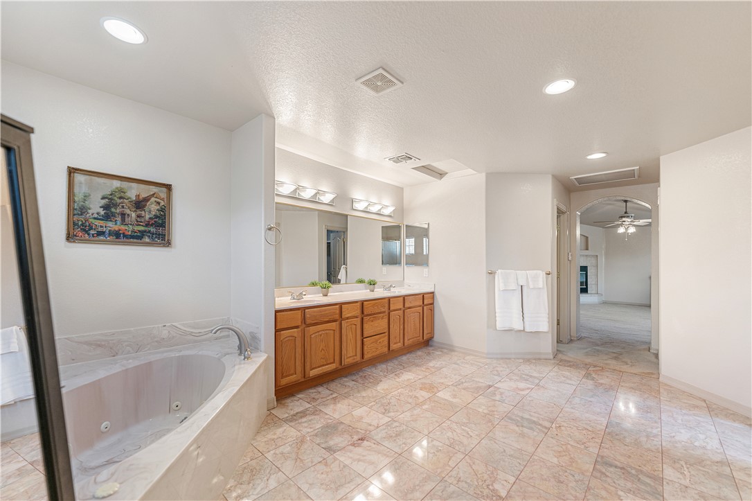 2940 Mountain Trail Road Kingman, AZ 86401 - Photo 21 of 53 a large spacious bathroom with a granite countertop tub shower sink and mirror