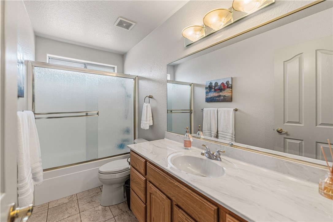2940 Mountain Trail Road Kingman, AZ 86401 - Photo 35 of 53 a bathroom with a sink toilet double vanity and shower