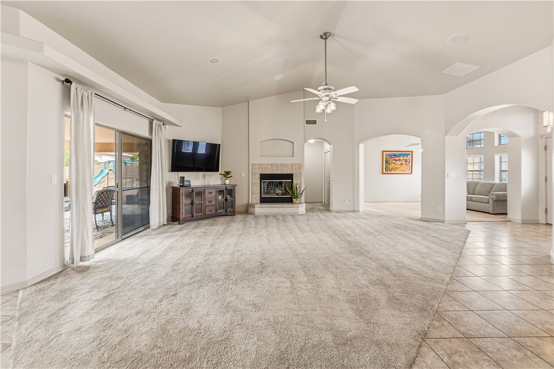 2940 Mountain Trail Road Kingman, AZ 86401 - Photo 4 of 53 a view of a livingroom with a fireplace a chandelier and windows