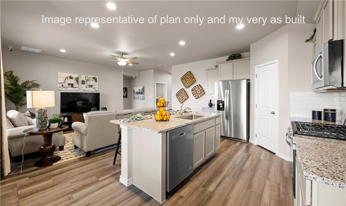1503 Choctaw Road Sinton, TX 78387 - Photo 15 of 29 a large kitchen with stainless steel appliances granite countertop a lot of counter space and wooden floors