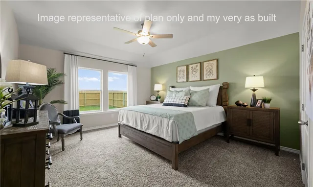 a spacious bedroom with a bed and a chandelier