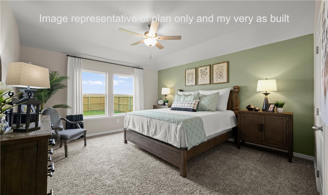 1503 Choctaw Road Sinton, TX 78387 - Photo 17 of 29 a spacious bedroom with a bed and a chandelier