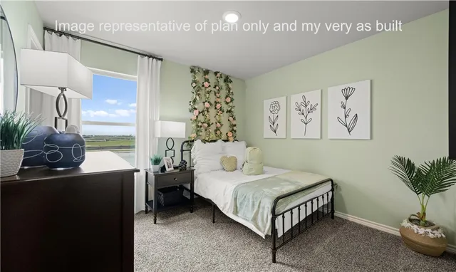 a bedroom with a bed potted plant with the mirror