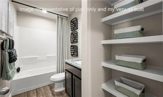 a bathroom with a shower a toilet and a sink