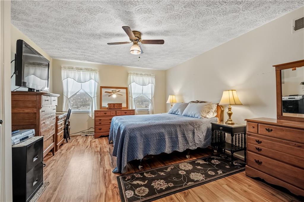 11 McKinley Square Coraopolis, PA 15108 - Photo 16 of 26 a bedroom with a bed and wooden floor