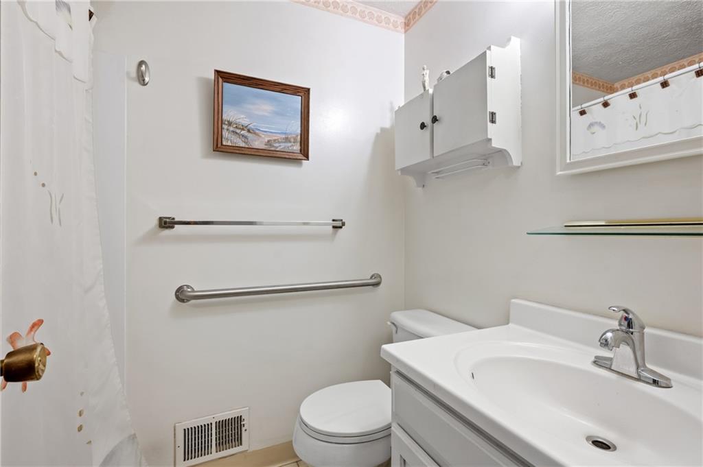 11 McKinley Square Coraopolis, PA 15108 - Photo 21 of 26 a bathroom with a toilet sink and mirror