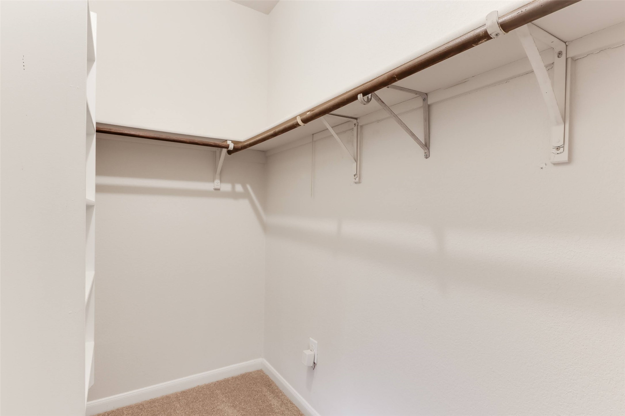 18705 Moreto Loop Pflugerville, TX 78660 - Photo 16 of 21 Well-appointed walk-in closet featuring ample hanging space and integrated shelving.
