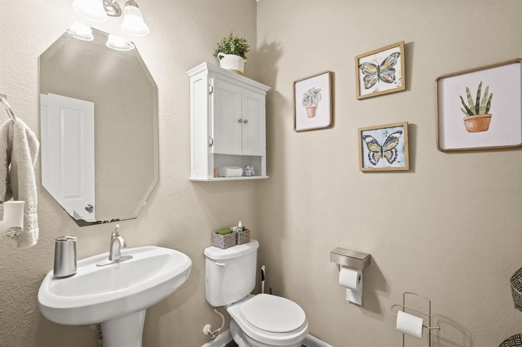 6719 Path Way Court Katy, TX 77449 - Photo 18 of 35 a bathroom with a toilet sink and mirror
