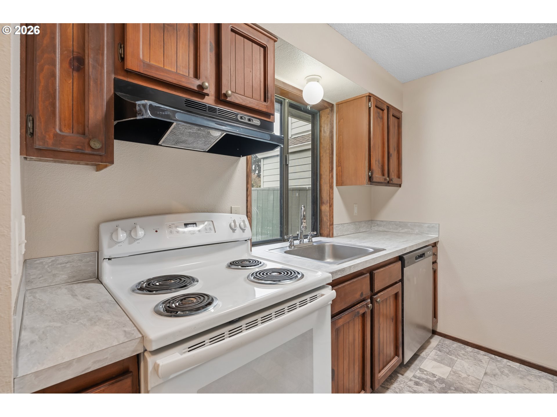 14807 Southwest 106th Avenue Portland, OR 97224 - Photo 11 of 37 a kitchen with a stove and a microwave
