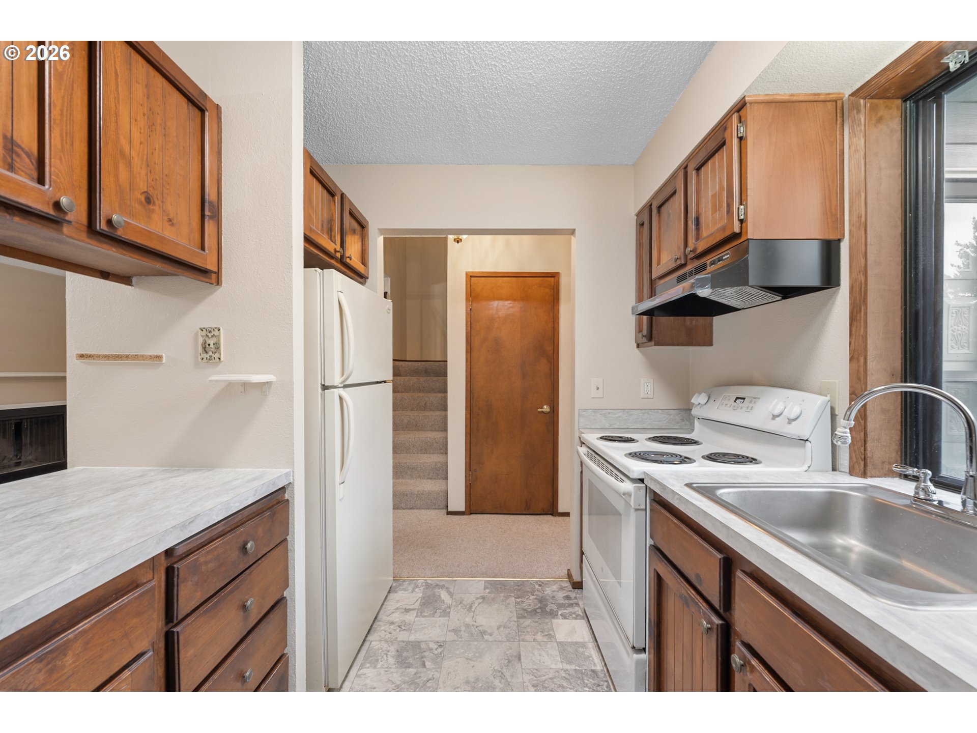 14807 Southwest 106th Avenue Portland, OR 97224 - Photo 13 of 37 a kitchen with stainless steel appliances granite countertop a sink stove and refrigerator