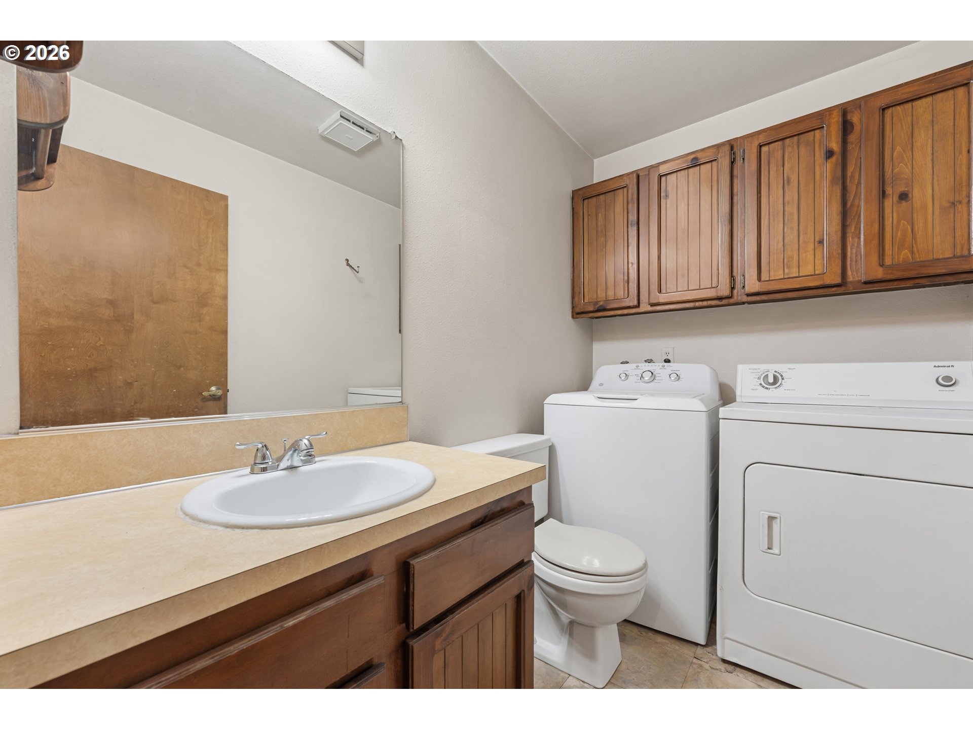 14807 Southwest 106th Avenue Portland, OR 97224 - Photo 17 of 37 a bathroom with a sink a toilet and a mirror