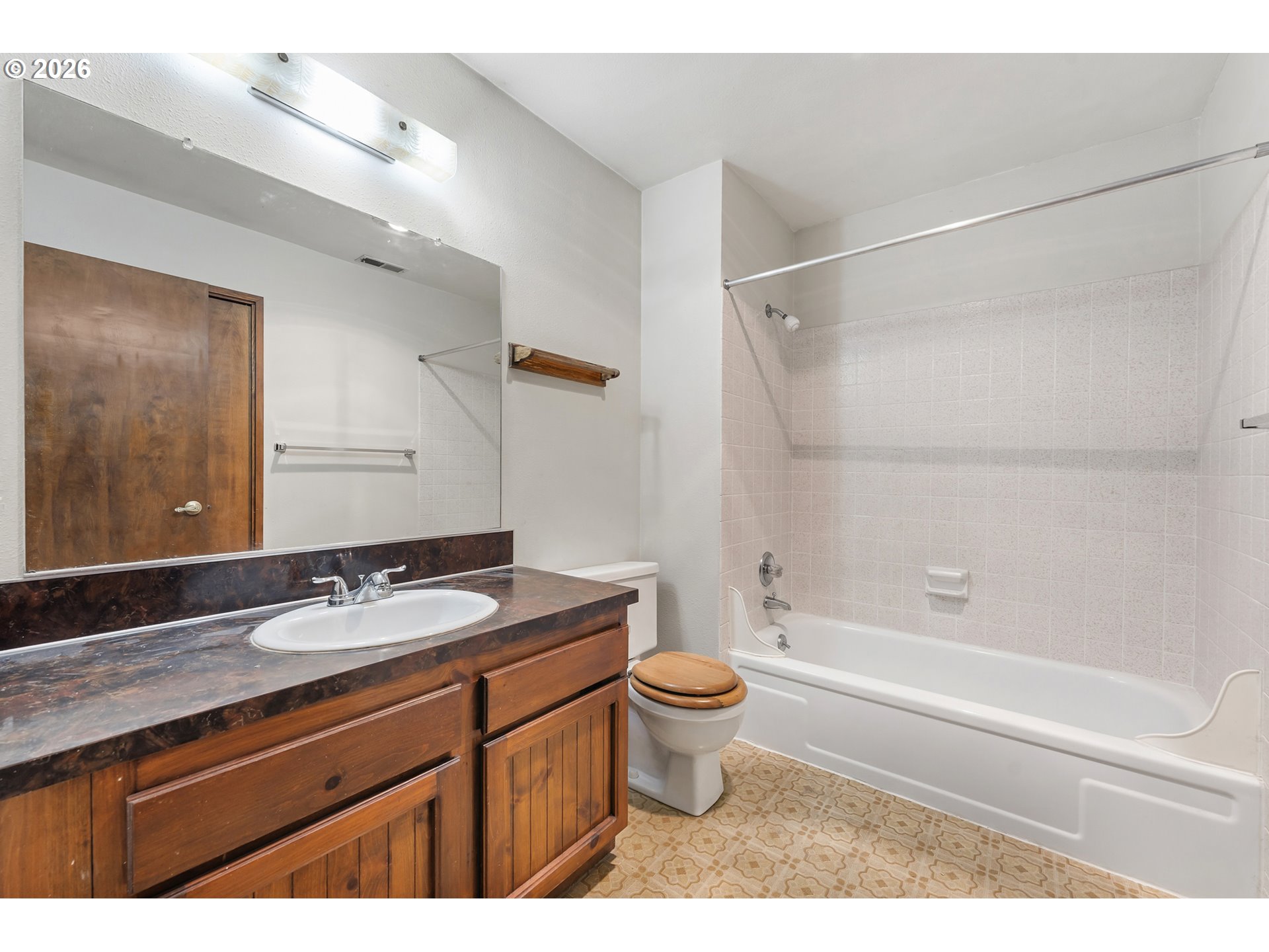 14807 Southwest 106th Avenue Portland, OR 97224 - Photo 22 of 37 a bathroom with a granite countertop sink toilet and shower